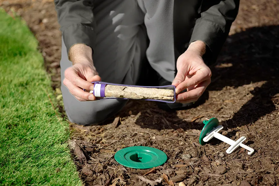 A Griffin Pest Solutions pest control technician showing termite bait in a bait station in Michigan.