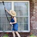 A woman spring cleaning windows for pest prevention.