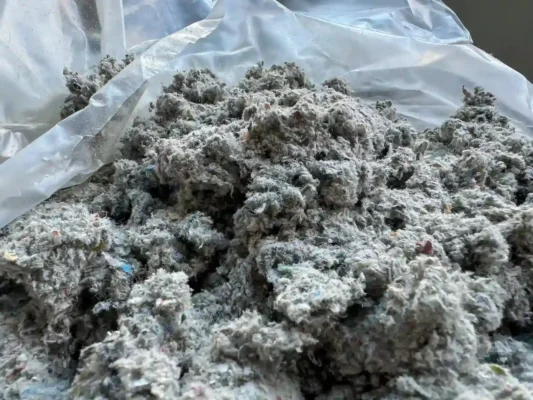 Attic insulation sample in a plastic bag